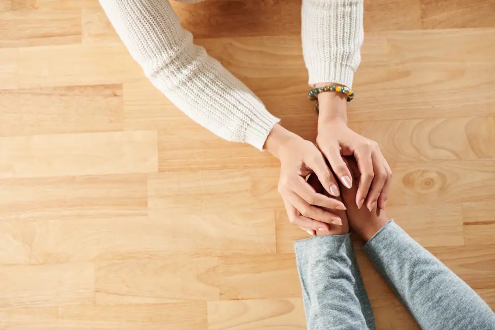 Two people holding hands.