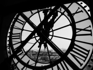 A black and white photograph of a giant clock window.